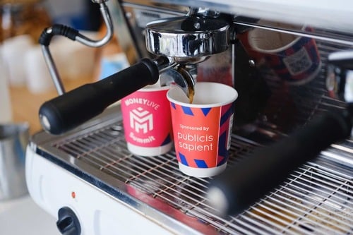 Coffee machine with MoneyLIVE branded cups